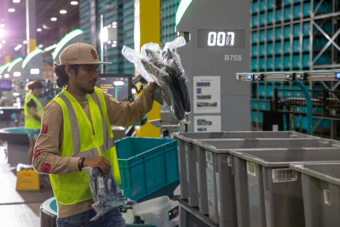 Exotec's order mover and an operator in a vest.