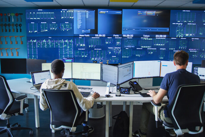 A group looking at the Deepsky warehouse optimization software in a control room.