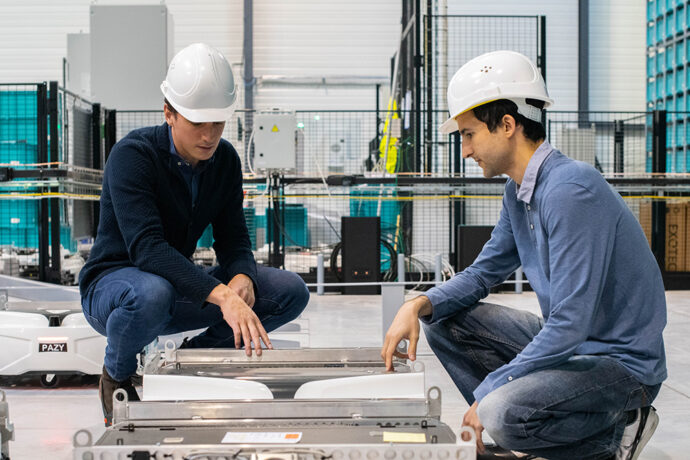 Two men in hard hats from Exotec's research and development team.