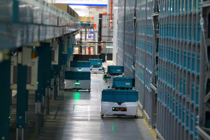 Six Exotec's Skypod autonomous mobile robots in a warehouse.