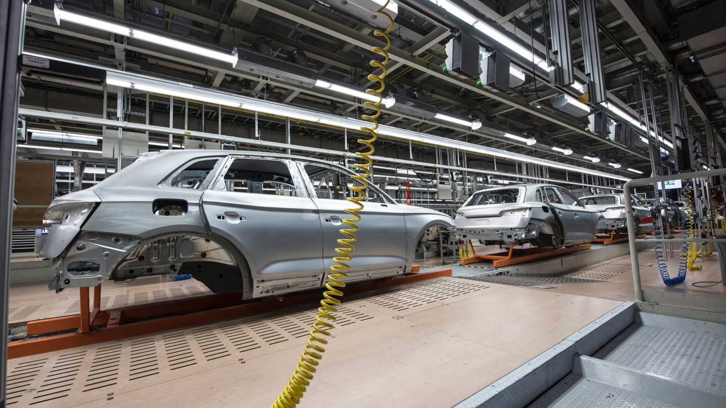 A car is being assembled in a factory.