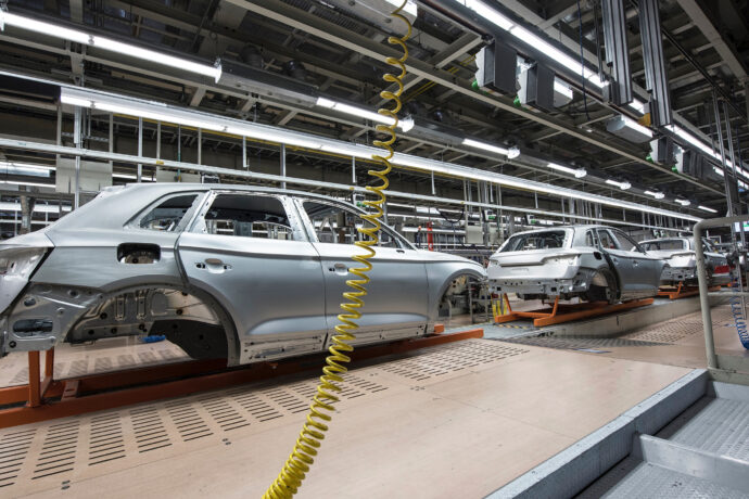 A car is being assembled in a factory.