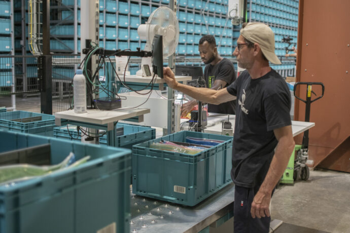 Warehouse operators fulfilling orders within a retail distribution center